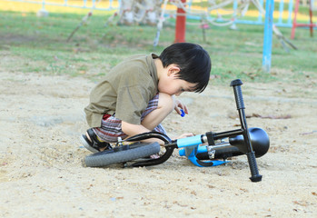 Asian boy with his bicycle in the park