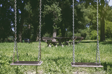Two swings at the park in spring