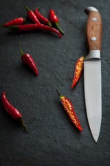 top view of chili peppers with sharp knife