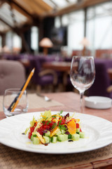 Tuna tartar with cucumber and orange on table