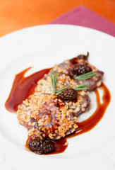 Venison fillet fried with pine nuts in plate