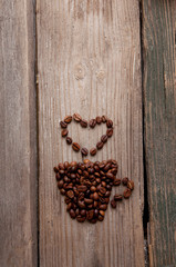 coffee beans and cup on wooden background