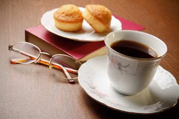 Tea, biscuits, book and glasses