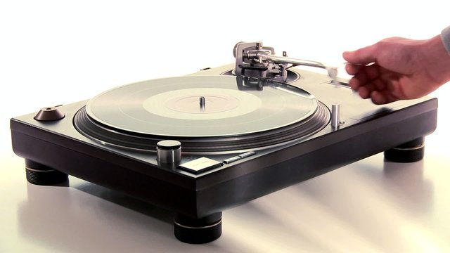 DJ Turntable. Dropping the needle on a spinning vinyl long-shot