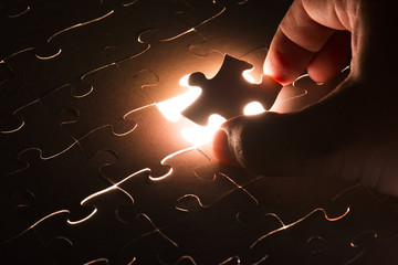 Missing jigsaw puzzle piece with light glow