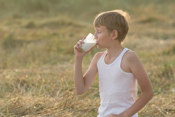 Teenage boy with closed eyes drinking milk