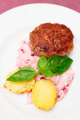 Beef patty cake with creamy sauce and potatoes