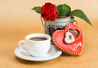 Valentines Day cookies with a cup of coffee and a rose.