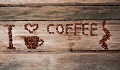 coffee beans and cup on wooden background