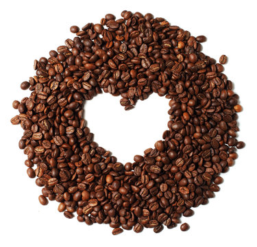 Image of heart shaped roasted coffee beans isolated on white bac