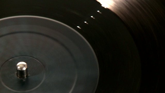 DJ Turntable. Top shot close-up of a spinning vinyl with needle