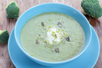 Broccoli puree soup with pupkin seeds and sprouts.