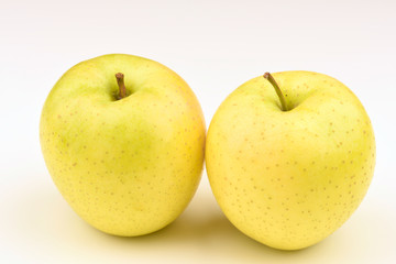 Ripe yellow apple on white background