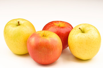Ripe yellow and red apple on white background