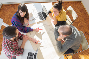 Young group of people discussing business plans.