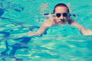 Fototapeta na wymiar Slim sportsman swimming.