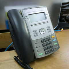 black telephone on table work of office