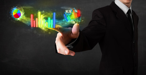 Handsome young business man touching colorful modern graph syste