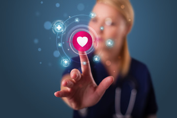 Young nurse pressing modern medical type of buttons
