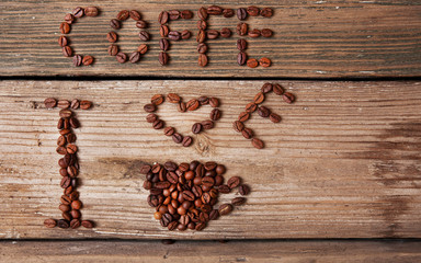 coffee beans and cup on wooden background