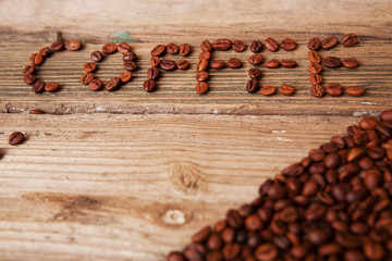 coffee beans and cup on wooden background