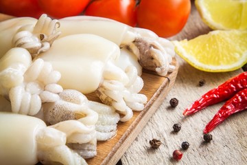 Raw babies cuttlefish  with lemon and peppers