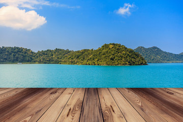 Wood floor and blue sea with island