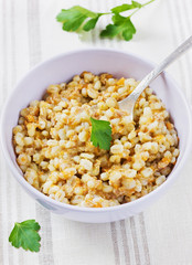 barley porridge with meat, vegetables and green parsley