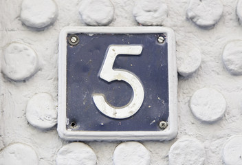 Number five on the wall of a house