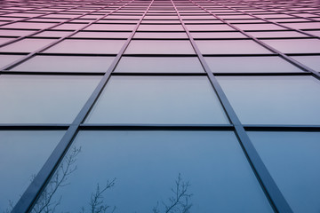 A wall of square glass windows on sunset