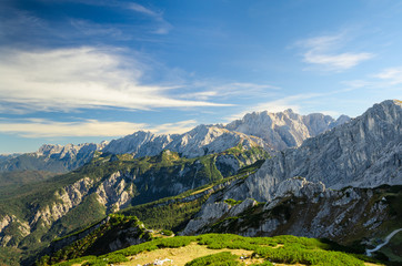 Alps sunlight high mountains peaks with green valley and blue sk