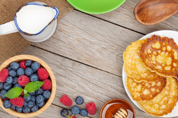 Pancakes with raspberry, blueberry, mint and honey syrup