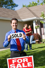 Home: Real Estate Agent with Sold Sign