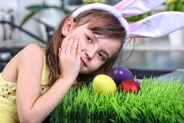 Little girl preparing traditional painted Easter eggs