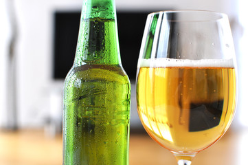 Glass of beer against TV-set