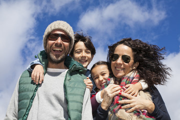 Familia feliz con ropas invernales en contrapicado