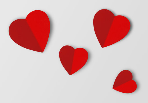 Beautiful paper hearts on grey paper background, close-up