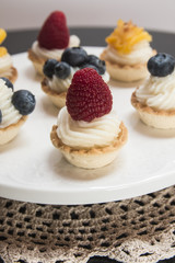 Sweet tartlets filled with cream and , blueberry, raspberry and