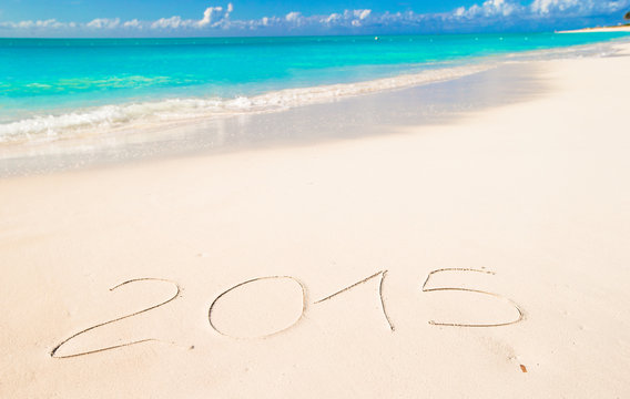 2015 written on tropical beach white sand