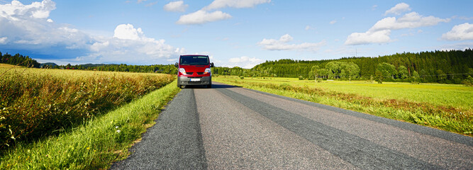 van, car driving on a beautiful narrow country road