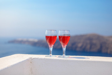 Two glasses of tasty red wine at sunset in Greece