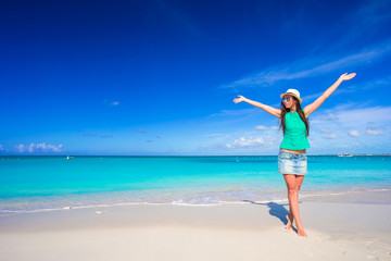 Young happy woman on beach during her summer vacation