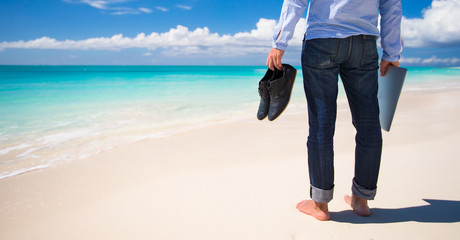 Young man with laptop during tropical beach vacation © travnikovstudio