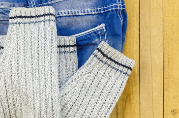 jeans and knitted sweater on the boards