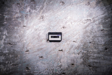 audio tape cassette on a concrete background
