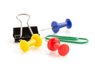 pushpin and paper clip on white background