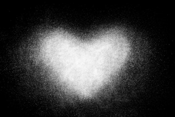 Fototapeta na wymiar Freeze motion of white heart shaped powder