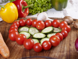 Fresh veggies arranged into heart shape on the table