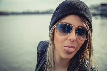 Fashionable girl showing tongue © sasamihajlovic