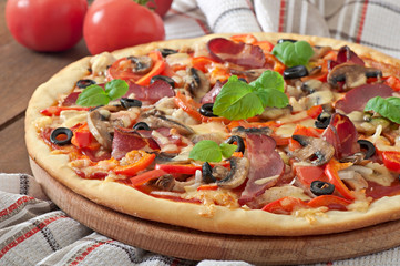 Pizza with ham, mushrooms and olives